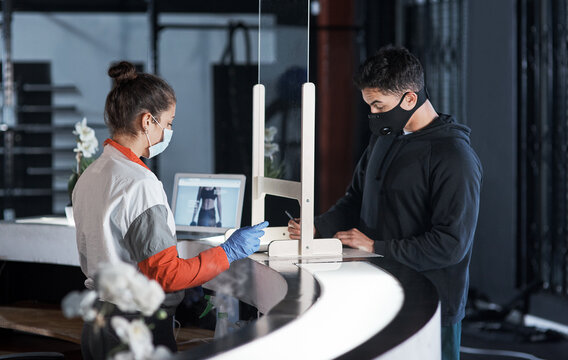 People, filling and paperwork with face mask safety for registration, policy compliance and fitness sign up. Woman, client and clipboard with sports contract, health checklist and review information - Powered by Adobe