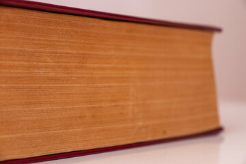  coloured damaged leather cover of a very old book. yellowed natural paper texture. isolated on white background. clean close-up.
