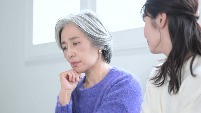 母親の相談を聞く娘と迷ったり困る母親の動画　うなずく、悩むなどのネガティブなイメージ