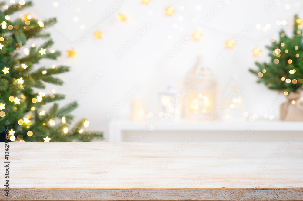 Wall mural front view of christmas table top with blurred fir tree and winter holiday decoration background