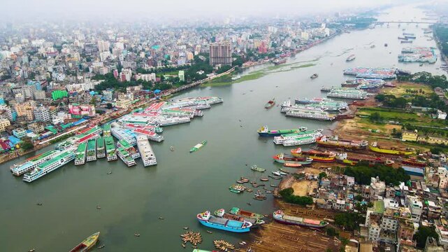 Wide aerial shot over Dhaka city&rsquo;s ship terminal on the Buriganga River, overlooking the many ships and the city skyline.