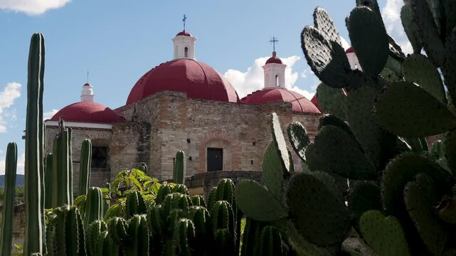 Slow motion landscape of cactus cacti plants in front of church temple of San Pablo in Mitla ancient archaeology site Zapotec city Oaxaca Mexico travel history tourism