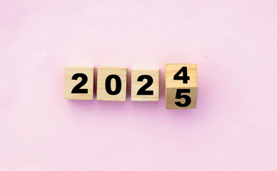 Year changing from 2024 to 2025 with wooden blocks symbolizing target business for the upcoming...