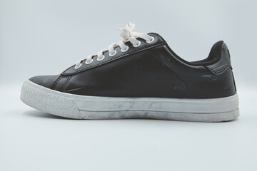 shoe sneaker on white background, close up of sneaker on white background, old black generic sneakers on white background.
