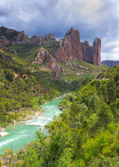 scenic view on Gallego river flowing with Mallos de rigos  background Aragon in Spain