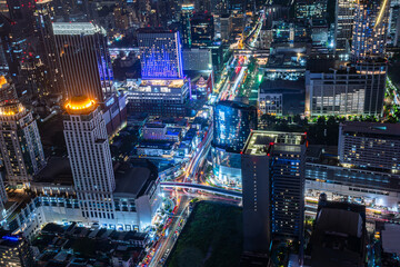 Beautiful modern high building and traffic on the road background.Business and apartment tower in big country.City square and skyline with modern buildings scenery, night time cityscape concept.