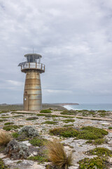 West Cape Lighthouse, an automatic lighthouse constructed of stainless steel, stands tall on a low shrub, rocky and windswept headland in Innes National Park on the Yorke Peninsula in South Australia.