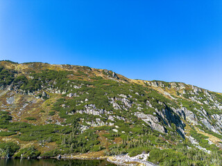 Naklejka premium Panorama of a mountain lake in Poland, Maly Staw and the Krkonose mountain range. Drone view
