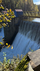 A dam on a river with water falling down. The Bobr River, Poland © PRO Balance