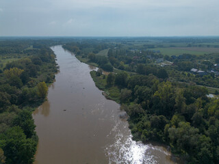 Mudflow of water in the Oder River of brown color. Poland. View from above. Background.