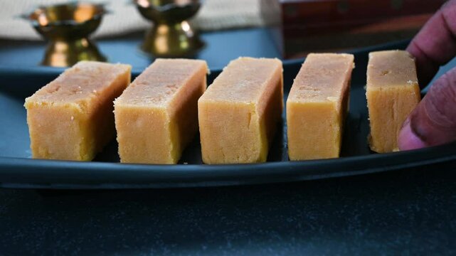 Serving mysore pak sweet dish in a plate.