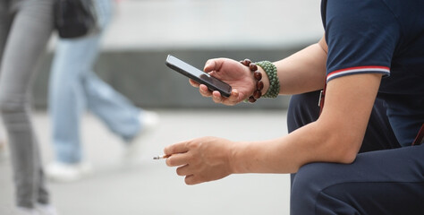 Man using smartphone in outdoors.