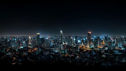 Obraz premium Panoramic view of a city skyline at night, illuminated by bright lights.
