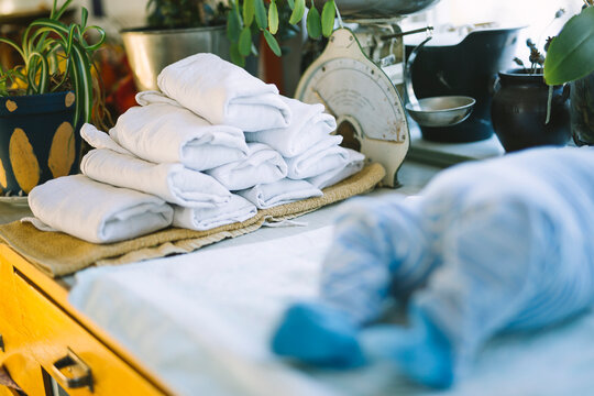 Stack of folded reusable cloth diapers on table