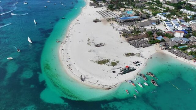 forward flying, aerial beach view, flight along white sand strand of Kendwa Beach area in  Kendwa a small village, located in the north part of Unguja Island, Zanzibar - aerial video footage 