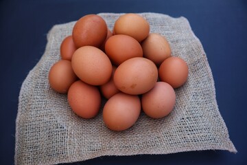 Chicken eggs are made in a pile with a close up view.