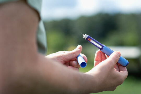 Hand of man holding diabetes insulin