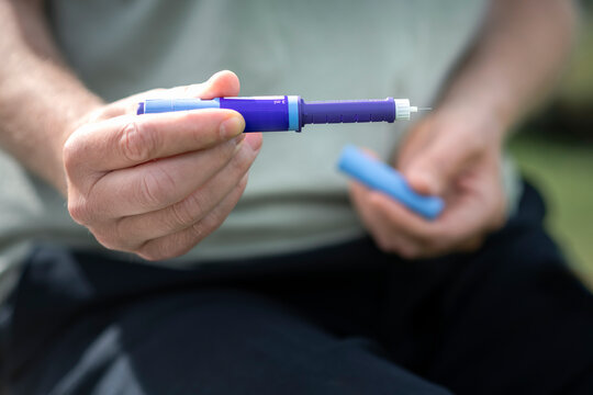Close-up of hand holding diabetes insulin