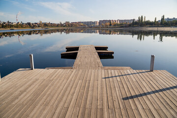 A beautifully crafted wooden dock gracefully extends into the crystalclear water, creating a serene...