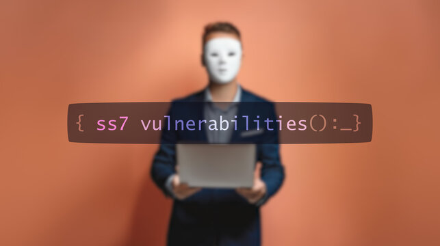 Cybersecurity concept ss7 vulnerabilities on foreground screen, hacker silhouette hidden with low poly style mask. Vulnerability and attack on colored code editor. Text in English, English text
