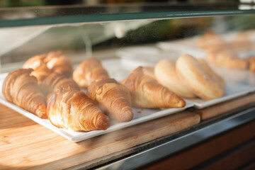 Fresh pastries on the counter behind the glass.