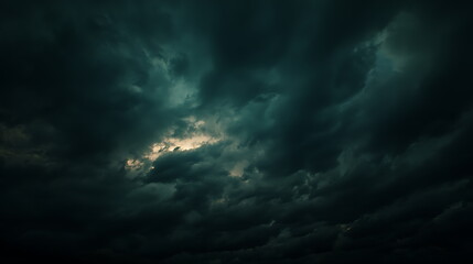 Obraz premium Dramatic and stormy clouds blanket the sky creating an ominous atmosphere with dark tones and eerie light flares