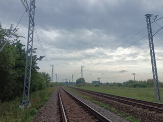 Two way railroad tracks in countryside. Two railway tracks. Cloudy day. Countryside. Fields and...