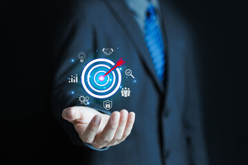Business goal setting concept. Businessman holding virtual target icon for business purpose. Strategic planning for business growth. Marketing strategy and goal for success.