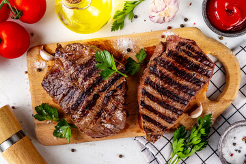 Grilled beef steak on wooden cutting board