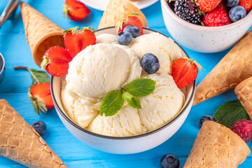 White ice cream bowl with vanilla gelato and fresh berries
