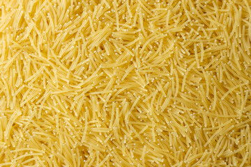 Uncooked Filini Pasta: A Culinary Canvas of Noodles, Creating a Lively and Textured Background for Gourmet Cooking. Dry Pasta. Raw Macaroni - Top View, Flat Lay