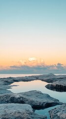 A tranquil tide pool reflecting the sunrise.