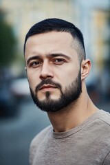 Obraz premium Portrait of a male designer Slavic appearance 25 years old with a short beard and dark short hair