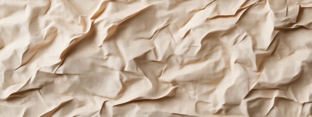 Obraz premium A close-up of crumpled beige paper, showcasing texture and natural folds.
