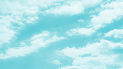 Fototapeta premium Blue pastel turquoise sky with white fluffy clouds. Cloudscape background. Soft blurred sky background. Freedom of life, New life beginning and Positive energy concepts.