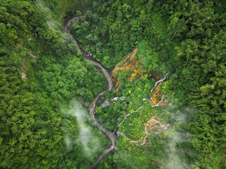 Aerial view of a magnificent waterfall in a lush forest
