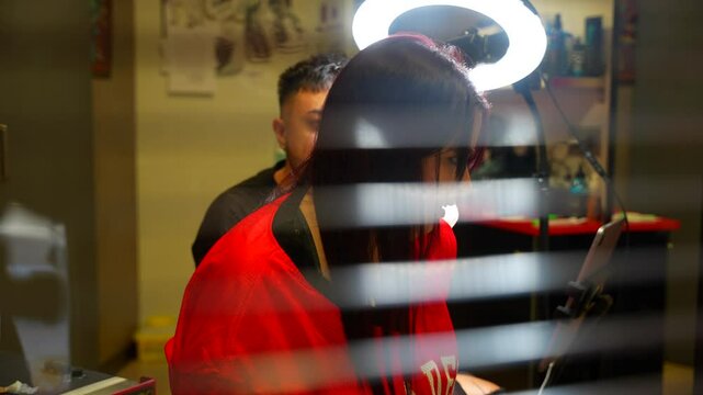 Funny tattoo session with client and artist behind curtain, 4K