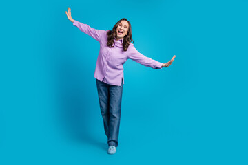 Full length photo of shiny attractive lady dressed purple blouse having fun empty space isolated blue color background
