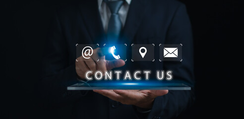 Customer contact us,hotline service concept, man using finger to touch contact information with icons on virtual screen to connect with customer feedback or suggestions, online marketing service