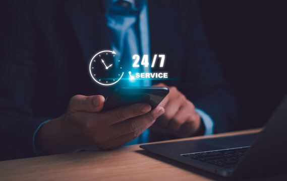 Nonstop service or full time customer service,24-7 Concept, Businessman using phone to answer customer question 24 hour a day for providing services around the clock without holiday, online marketing
