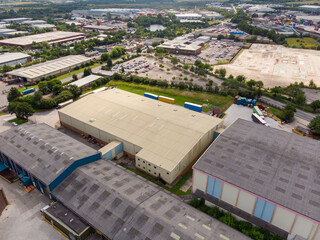 Aerial drone photo of a large warehouse and storage unit located in the town of Hunslet in the city of Leeds in West Yorkshire in the UK showing the large distribution site and roads from above