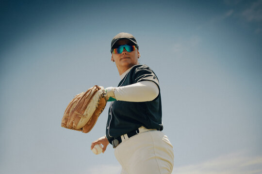 Baseball player poised to pitch with mitt, conveying focus and determination on the field
