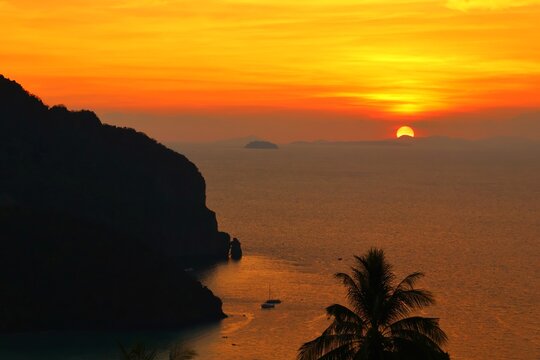 Sunset boat floating over the peaceful tropical sea