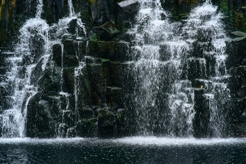 Beautiful Rochester Falls in Mauritius, Africa, showcasing cascading waters over rugged volcanic rock formations, surrounded by lush tropical greenery