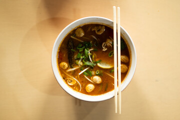 Flavorful Tom Yum soup ready to enjoy on table.