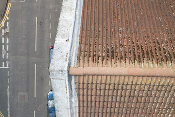 Aerial photo of a typical British terrace house in the UK showing the roof and tiles with lead flashing and shingles and dirty roof in need of a clean and scraping off the moss from the tiles