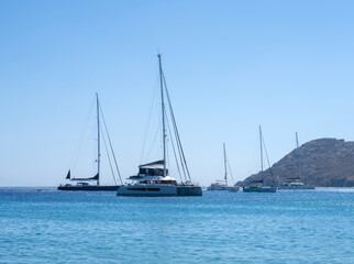 Fototapeta premium Beautiful yachts and catamarans in the Mediterranean Sea on the island of Mykonos in Greece