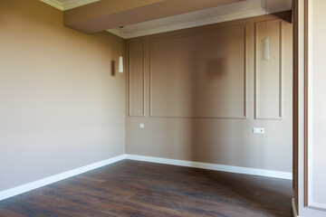 A room with a white wall and wooden floor