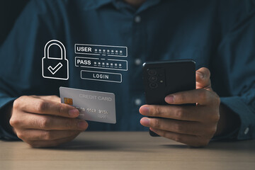 Businessman using mobile phone with cyber security login screen and holding credit card. Digital information technology and cyber security concept.