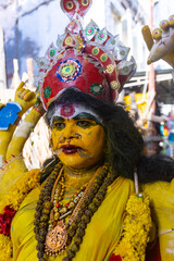 Kulasai Dasara, Portrait of indian woman with painted face and dressed as hindu god kali to perform...